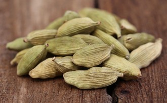 Cardamom seed on wooden surface