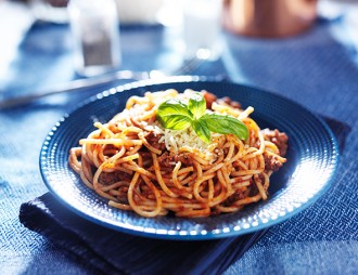 delicious spaghetti in bolognese sauce with basil garnish